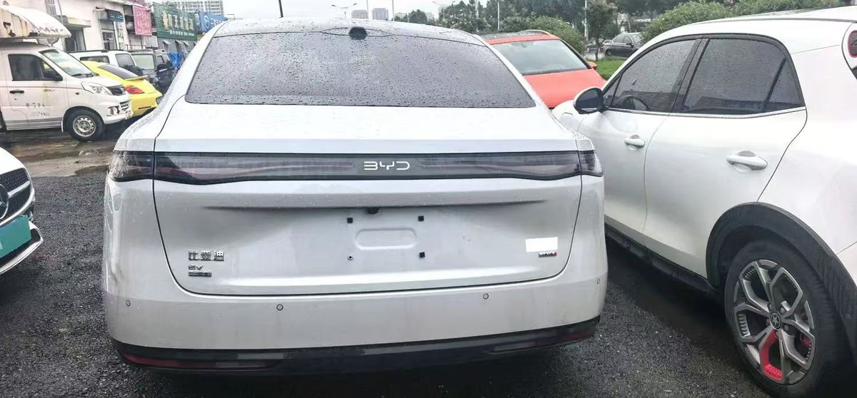White BYD sedan, rear exterior view