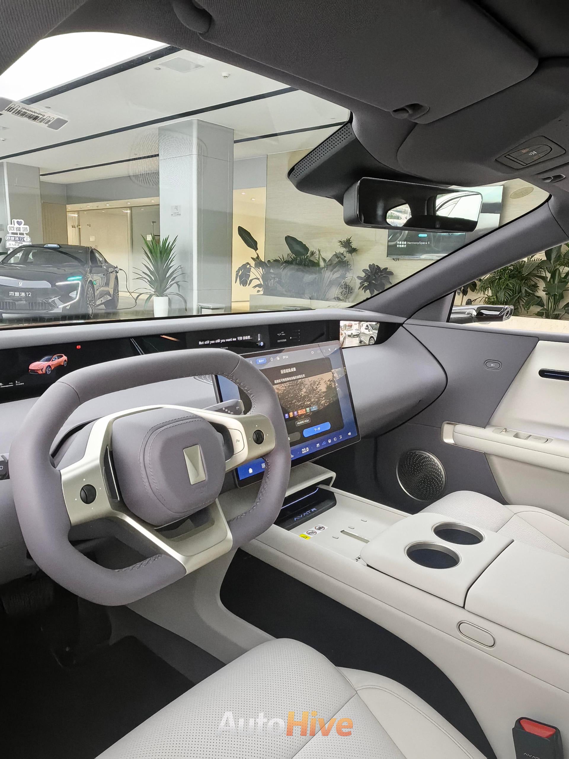 Huawei avatr 12 Car interior with steering wheel and dashboard display in a showroom setting